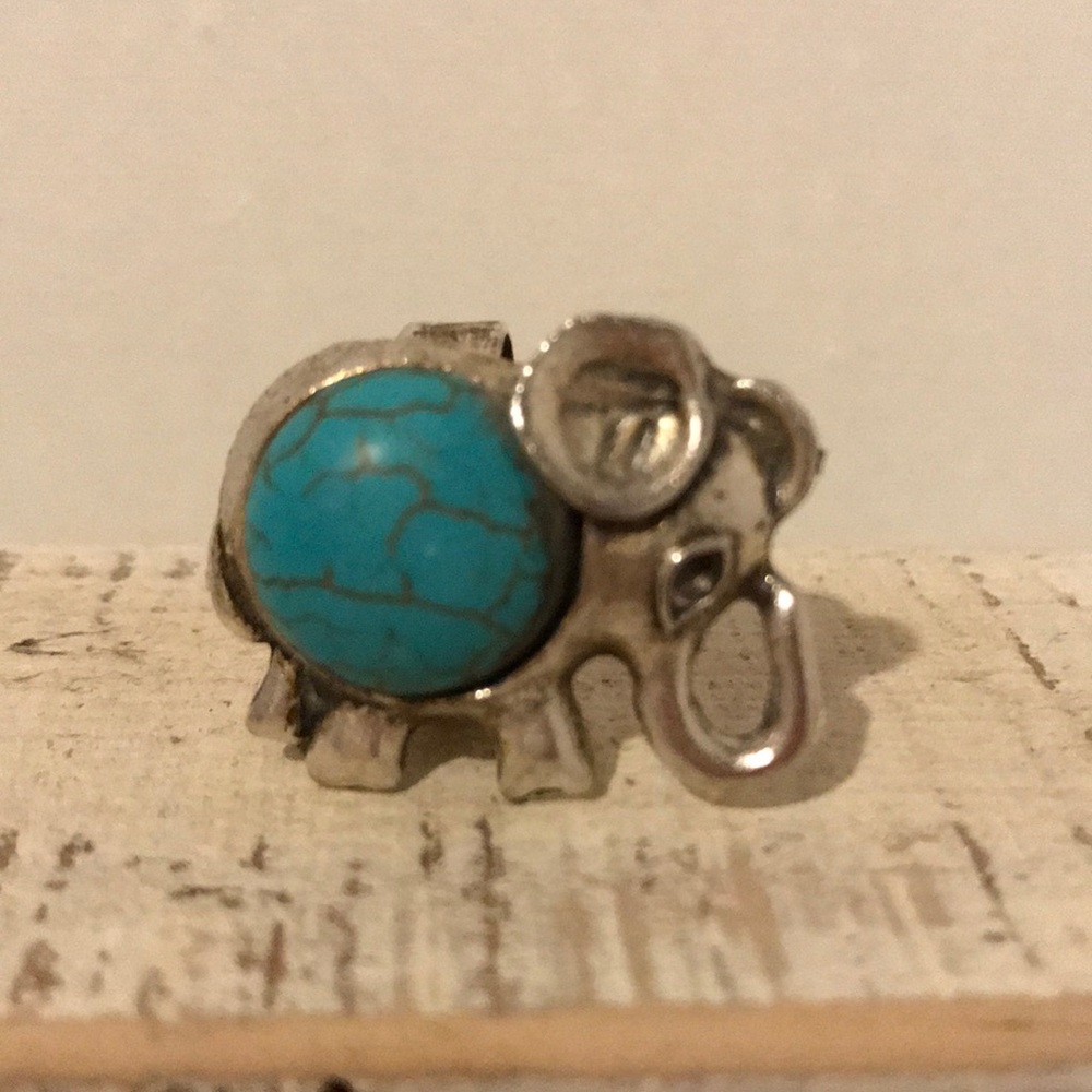 Silver elephant ring with turquoise colored stone.